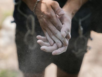 Close up of an athlete hands with chalk.